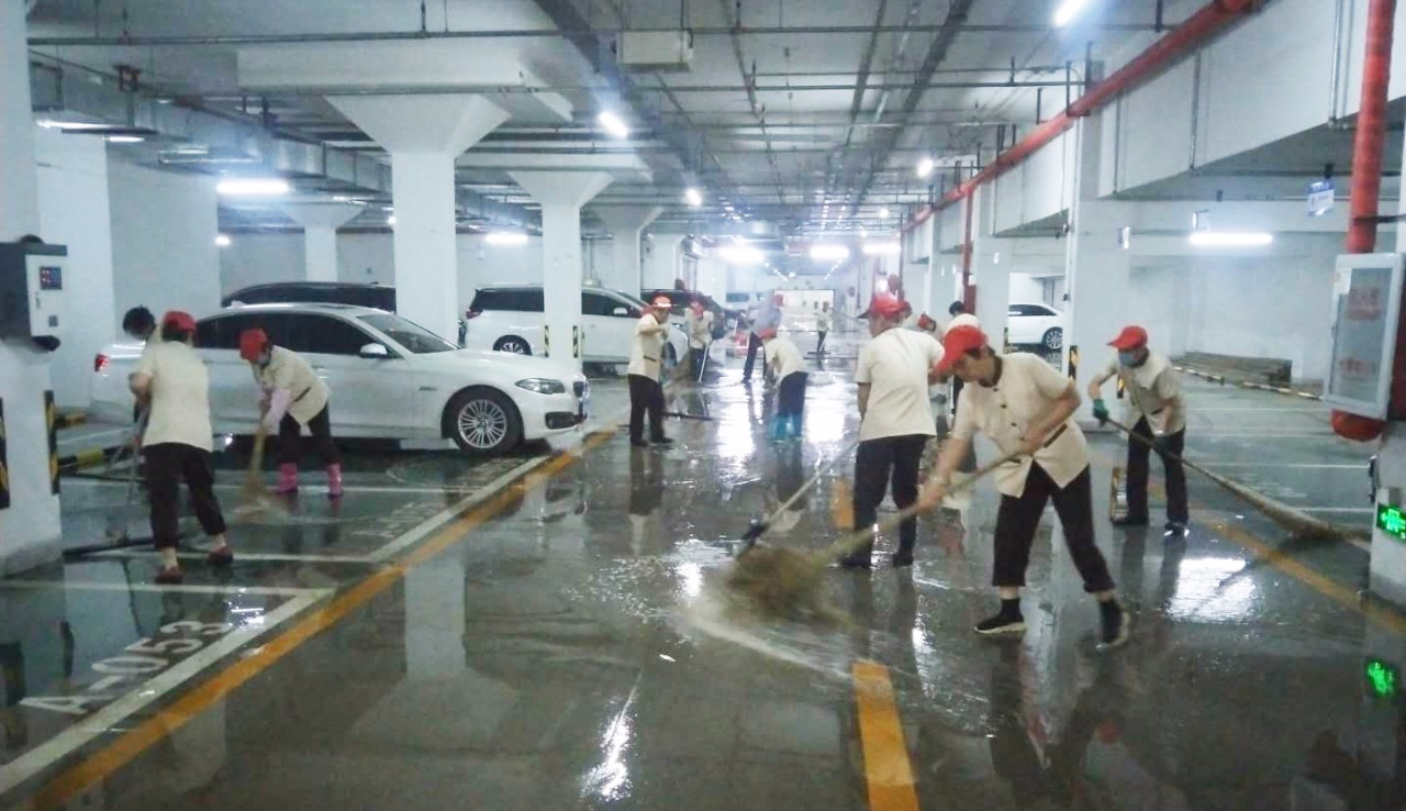 【企业资讯】风雨中的坚守，一线保洁员雨后清理道路积水淤泥